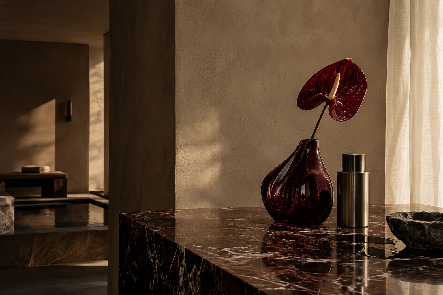 Original SOCELLE concept: monochrome anthurium, sculptural glass and a metal vessel in a stone interior